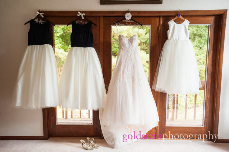 Bride Gowns and Bridesmaid Dresses Hanging on Door at House before Wedding